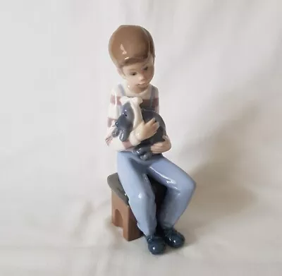 Buy Nao By Lladro Porcelain Figure - Boy Holding A Dog In Bow Sitting Down • 28£