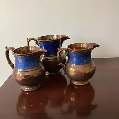 Buy 3 Lustre Ware Jugs Brown With Blue Decoration’s  • 12£
